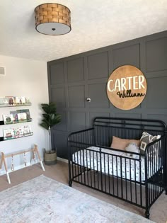 a black metal crib in a room with gray walls and white rugs on the floor