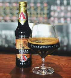 a bottle of beer next to a glass on a table