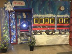 a train themed classroom door decorated with christmas lights and snowflakes, along with potted plants