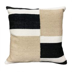 a black and white pillow with two squares on the front, one in different colors