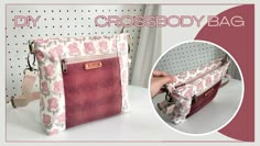 the cross body bag is made from fabric and has pink flowers on it, with a zipper