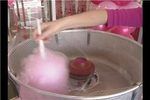 a woman is pouring pink liquid into a large metal pot