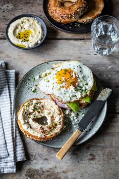 an open face sandwich on a plate with eggs