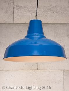 a blue light hanging from the side of a wall