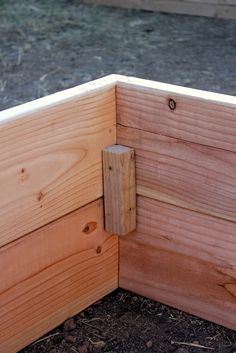 the corner of a wooden box with a latch on it