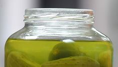 a glass jar filled with lemons and limeade