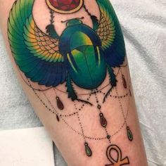 an egyptian scarp with jewels on it and the symbol of love is depicted in this tattoo