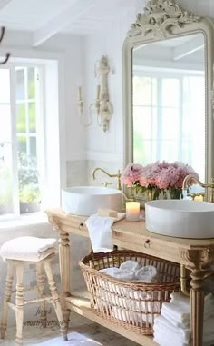 a bathroom with two sinks and a large mirror