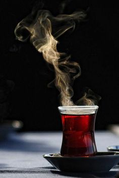 a cup filled with liquid sitting on top of a table