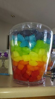 a plastic container filled with gummy bears on top of a table