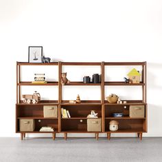 a wooden shelf with baskets and books on it