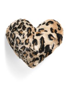 a heart shaped animal print pillow on a white background