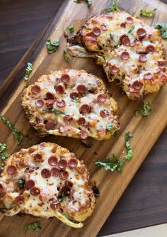 three pieces of pizza sitting on top of a wooden cutting board