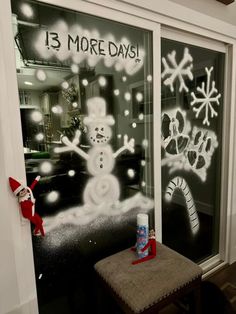 a frosted glass window with snowmen and christmas decorations on the windowsills