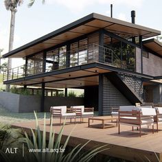 a modern house with outdoor furniture on the deck