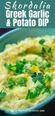 a bowl filled with green garnish and potato dip