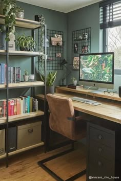 a desk with a computer on top of it next to a book shelf filled with books