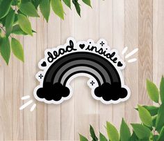 a sticker that says good inside with a rainbow in the middle on a wooden background