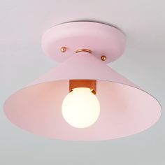 a pink ceiling light hanging from the ceiling