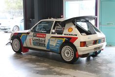 an old race car is parked in a garage