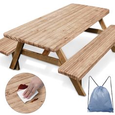 a wooden picnic table with two benches and a bag next to it