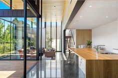 the kitchen and living room are separated by glass walls