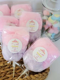 pink and white marshmallows in a basket with labels on them for birthday party favors