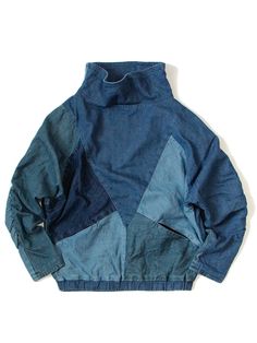 a blue jacket that is sitting on top of a white surface and it has an open zipper