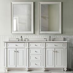 two mirrors are above the double sink vanity in this bathroom with white walls and flooring