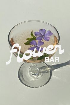 there is a flower in the bottom of a glass that says flower bar on it