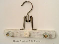 a pair of hooks hang on a white wall