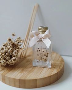 a bottle of perfume sitting on top of a wooden tray