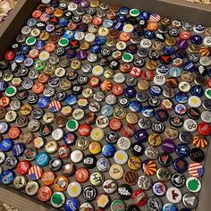 a box filled with lots of different types of beer bottle cap covers and magnets