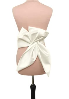 This big fashion bow is made from ivory Duchess satin and can be perfect choice for your glamour bridal look. The length of the bow is about 50cm. Our bow can be ordered separate or with belt. Can be made in soft matte satin, duchess satin or Mikado fabric. ALL OF OUR PRODUCTS ARE HANDMADE BY US AND MADE WITH THE BEST HIGH-QUALITY FABRICS. If you have any questions about our products do not hesitate to contact us! SAMPLES(SWATCHES) LOWER COST SHIPPING, FOR CUSTOMER FROM OUTSIDE THE UK PLEASE USE THIS LINK FOR SAMPLES(SWATCHES): https://www.etsy.com/uk/listing/949775560/fabrics-samples-swatches-glitter-tulle?ref=listings_manager_grid *DELIVERY We use standard delivery service for the UK with Royal Mail 1st class service which normally takes 1-2 working days without tracking. For internation Dress With Bow Belt, Bow Belt Dress, Chic Evening Bow With Detachable Feature, White Fitted Dress With Detachable Bow, Classic Detachable Bow, Luxury Satin Bow Tie Back Bow, White Detachable Bow For Evening, Chic Mini Wedding Dress With Detachable Bow, Wedding Dress Bow