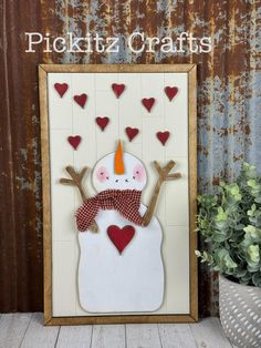 a snowman made out of paper with hearts on it and the words pickitz crafts above it