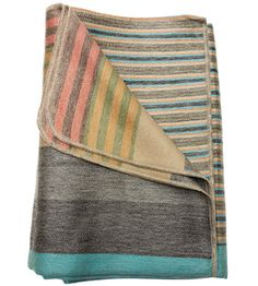 a multicolored blanket folded on top of each other