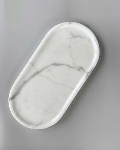 a white marble tray on a gray surface