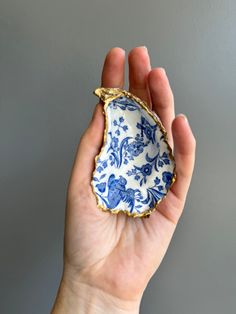 a hand holding a small blue and white plate