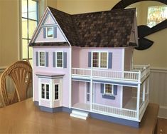 a doll house sitting on top of a wooden table