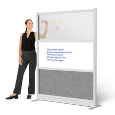 a woman standing next to a whiteboard with writing on it