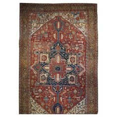 an antique persian rug with red and blue colors