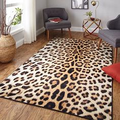 a living room filled with furniture and a leopard print rug