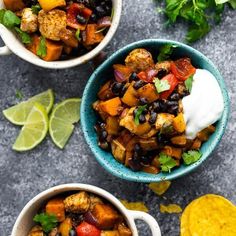 two bowls filled with mexican food next to tortilla chips and lime wedges