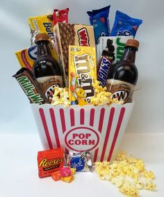 a popcorn bucket filled with snacks and drinks