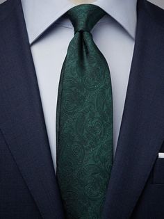 a man in a suit with a green tie