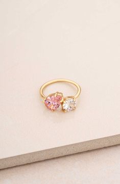 A mixed duo of cubic zirconia shimmers brilliantly atop this slender ring band plated in 18-karat gold. Cubic zirconia/18k-gold plate Imported Pink Gemstone Rings, Colorful Promise Rings, Couple Birthstone Ring, Gold And Pink Ring, Senior Ring, Eclectic Engagement Rings, Senior Rings, Barbie Ring, Pink Rings