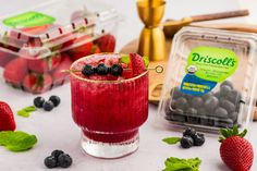 berries and blueberries sit on the table next to drinks