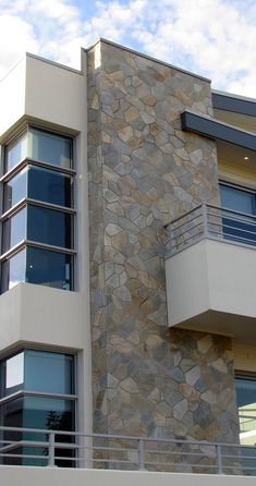 a tall building with windows and balconies on the side