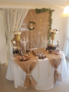 a table is set up with gold and white decorations