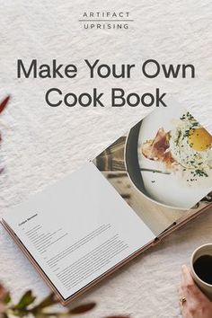 an open cookbook sitting on top of a table next to a cup of coffee